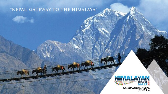 Trekkers crossing a suspension bridge in the Himalayas.
