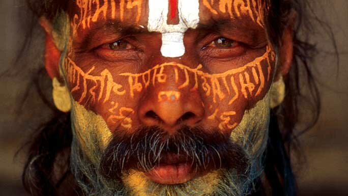 A yogi with holy text on his face during the Maha Shivaratri at Pashupatinath Temple in Kathmandu, Nepal. 