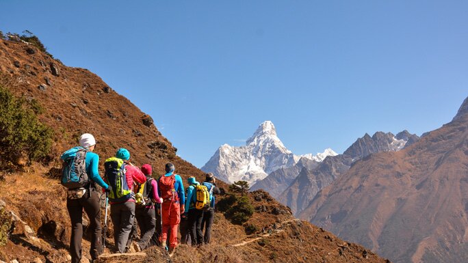 A group of trekkers in the Everest region with Mt. Ama Dablam in the background